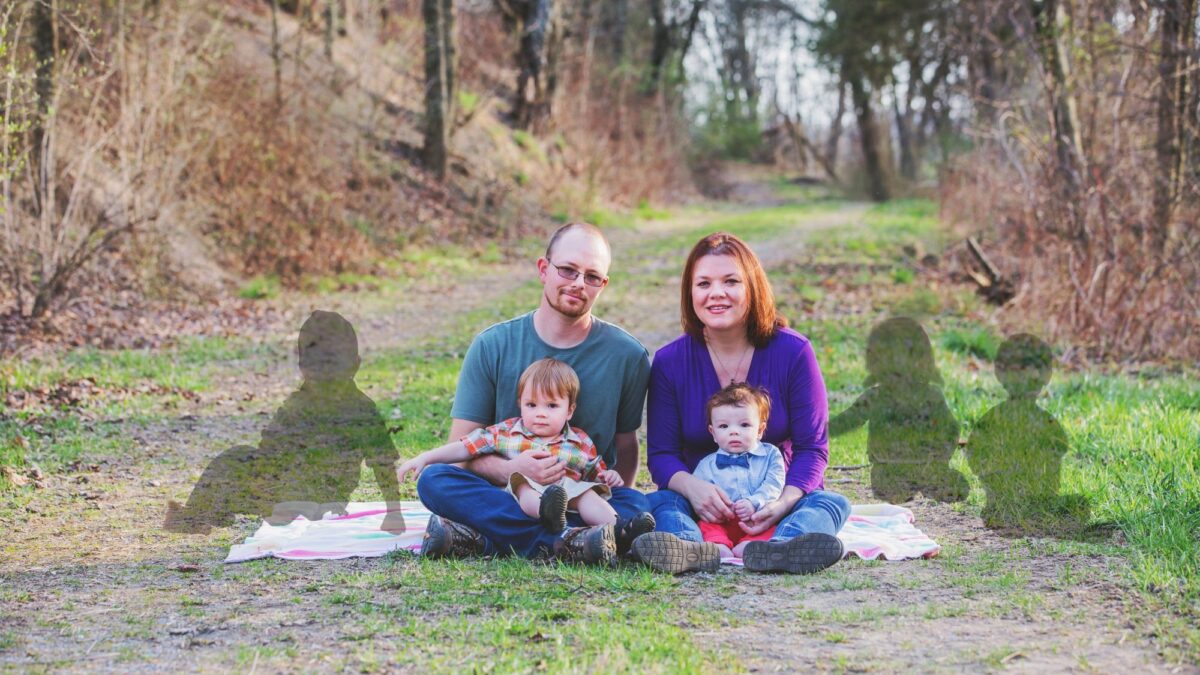The family sits on the ground.