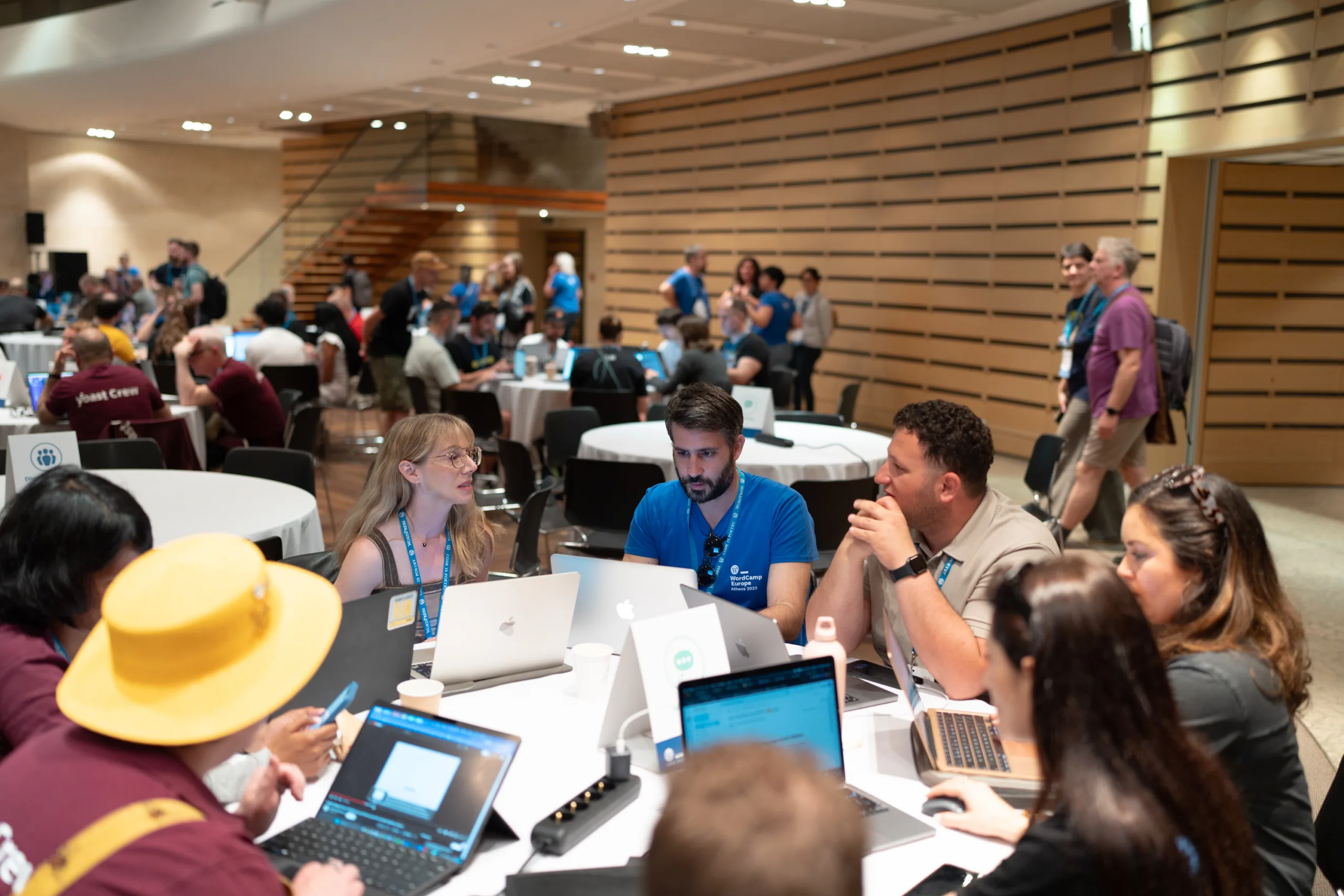 Many tables at WordCamp Europe contributor day. Not visible: WordPress Core.