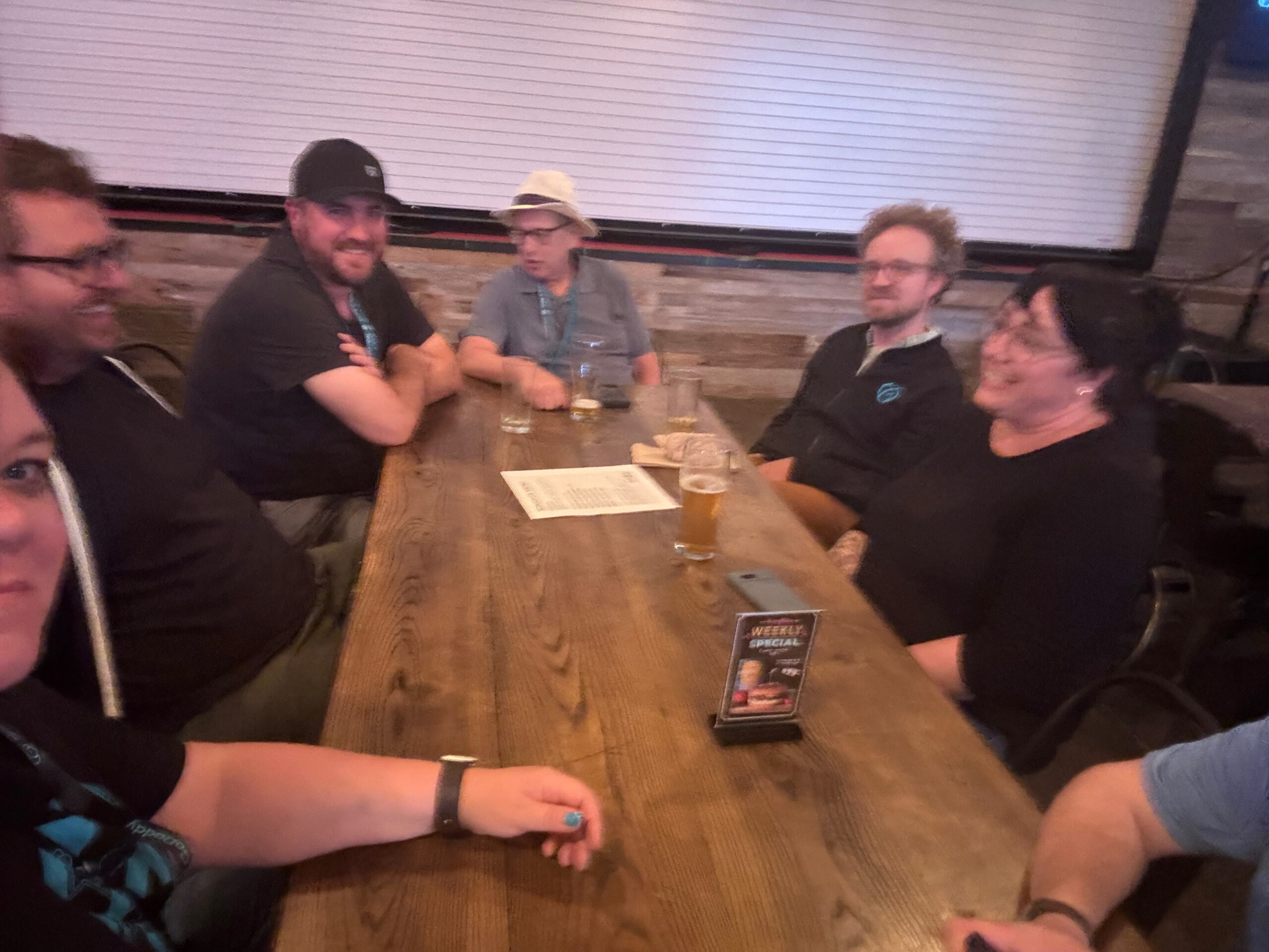 Courtney, Ian Misner, Marcus Burnette, Bud, Ryan, Kat sit at the table smiling