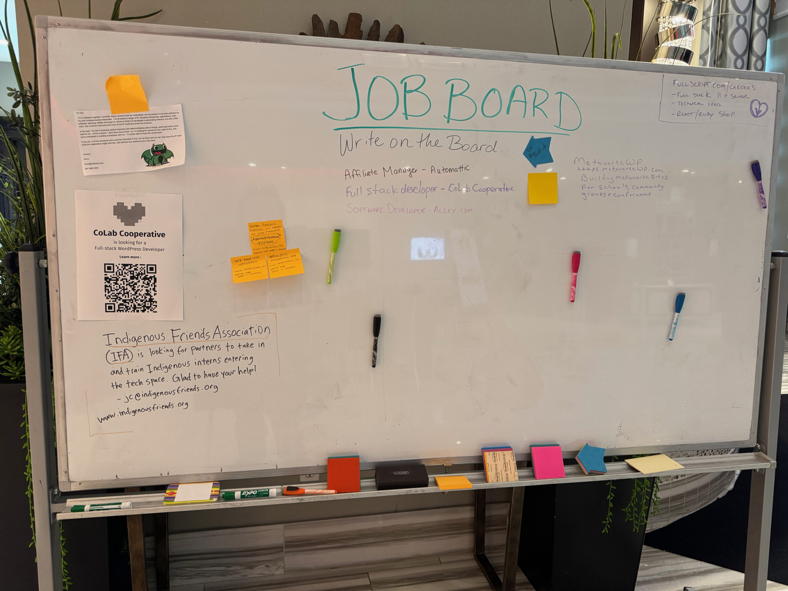 WordPress Jobs Board is a marker board with many markers and post it notes nearby.  The photo is taken at a distance and the text too small to read.